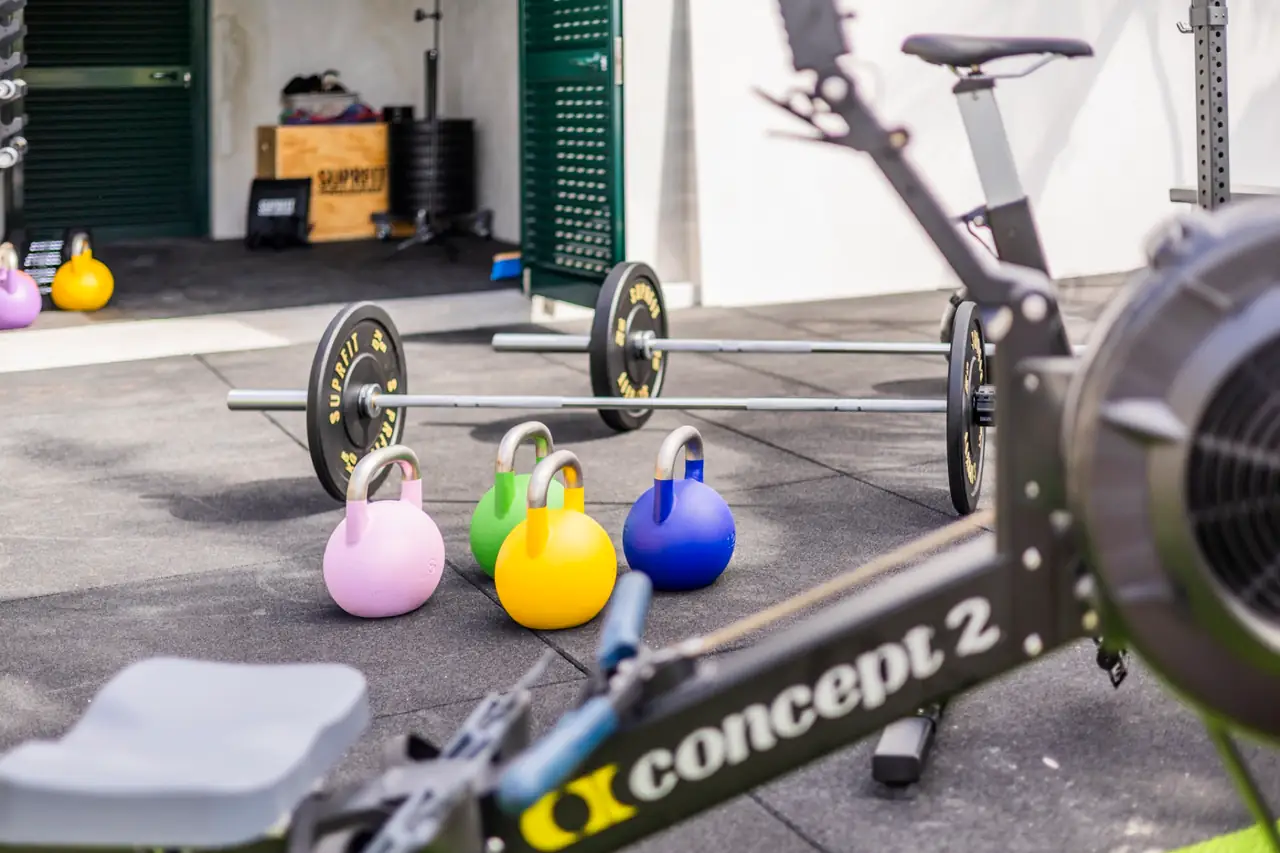 Concept2 rower with kettlebells and barbells in the gym, Villa Crossdeira
