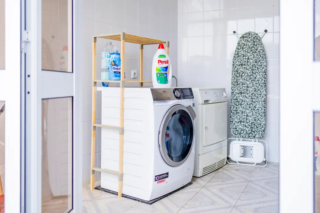 Laundry room with washing machine, tumble dryer and ironing board, Villa Crossdeira