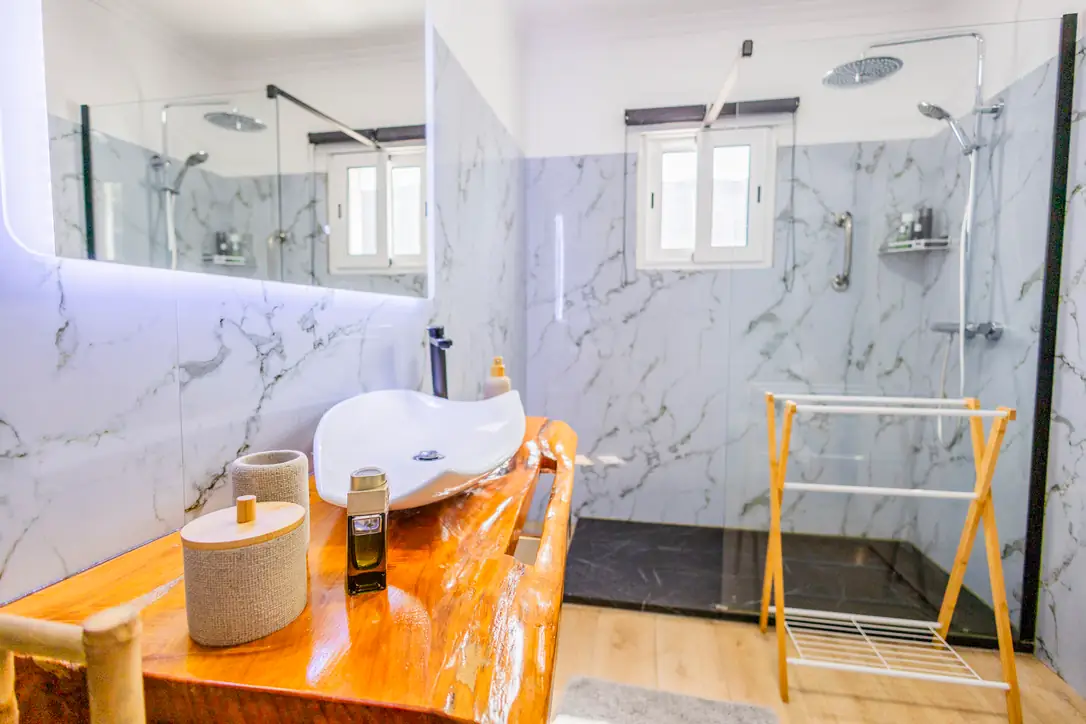 Master bathroom with marble walk-in shower and stone washbasin, Villa Crossdeira