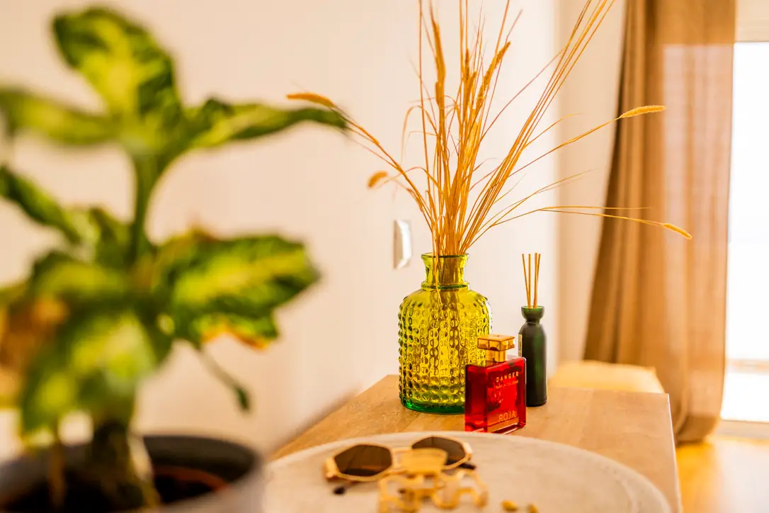 Green glass vase with dried grasses on the master bedroom table, Villa Crossdeira