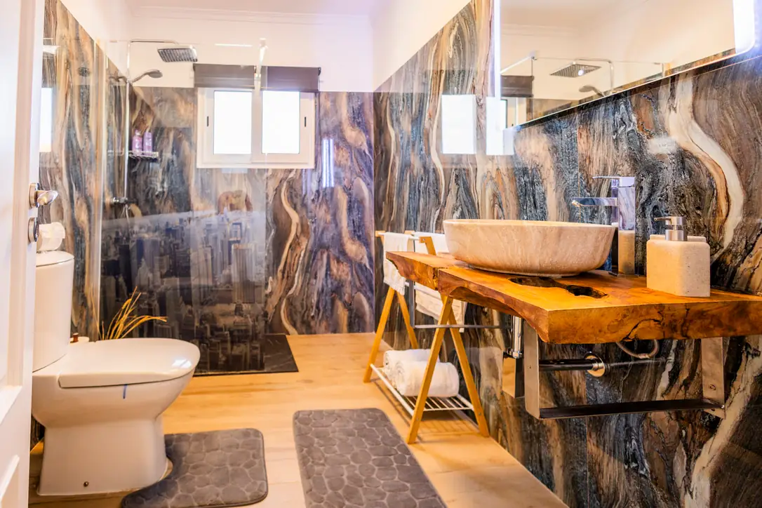 Ocean Bedroom en-suite bathroom with blue marble walls and wooden vanity, Villa Crossdeira