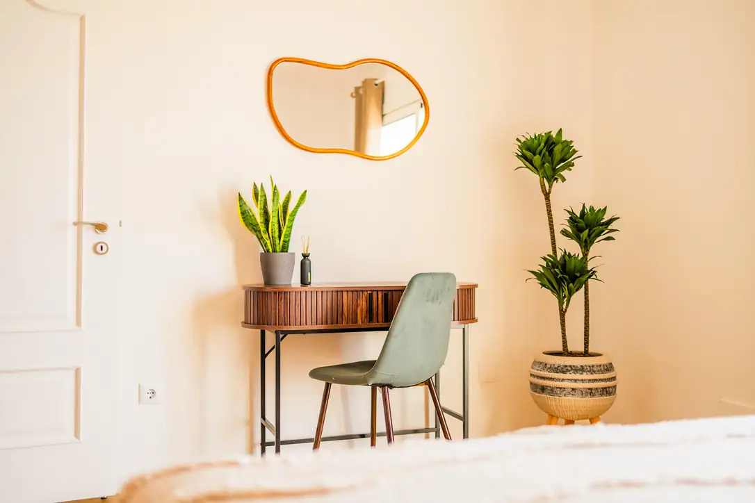 Work desk with velvet chair and plants in the Ocean Bedroom, Villa Crossdeira