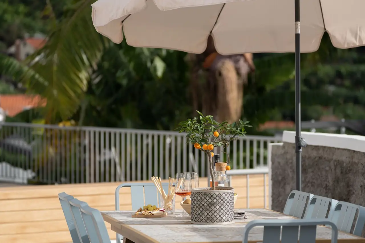 Outdoor dining table under a parasol on the terrace, Villa Crossdeira