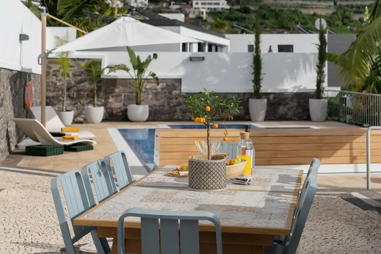 Outdoor dining table next to the pool with view of the villa, Villa Crossdeira