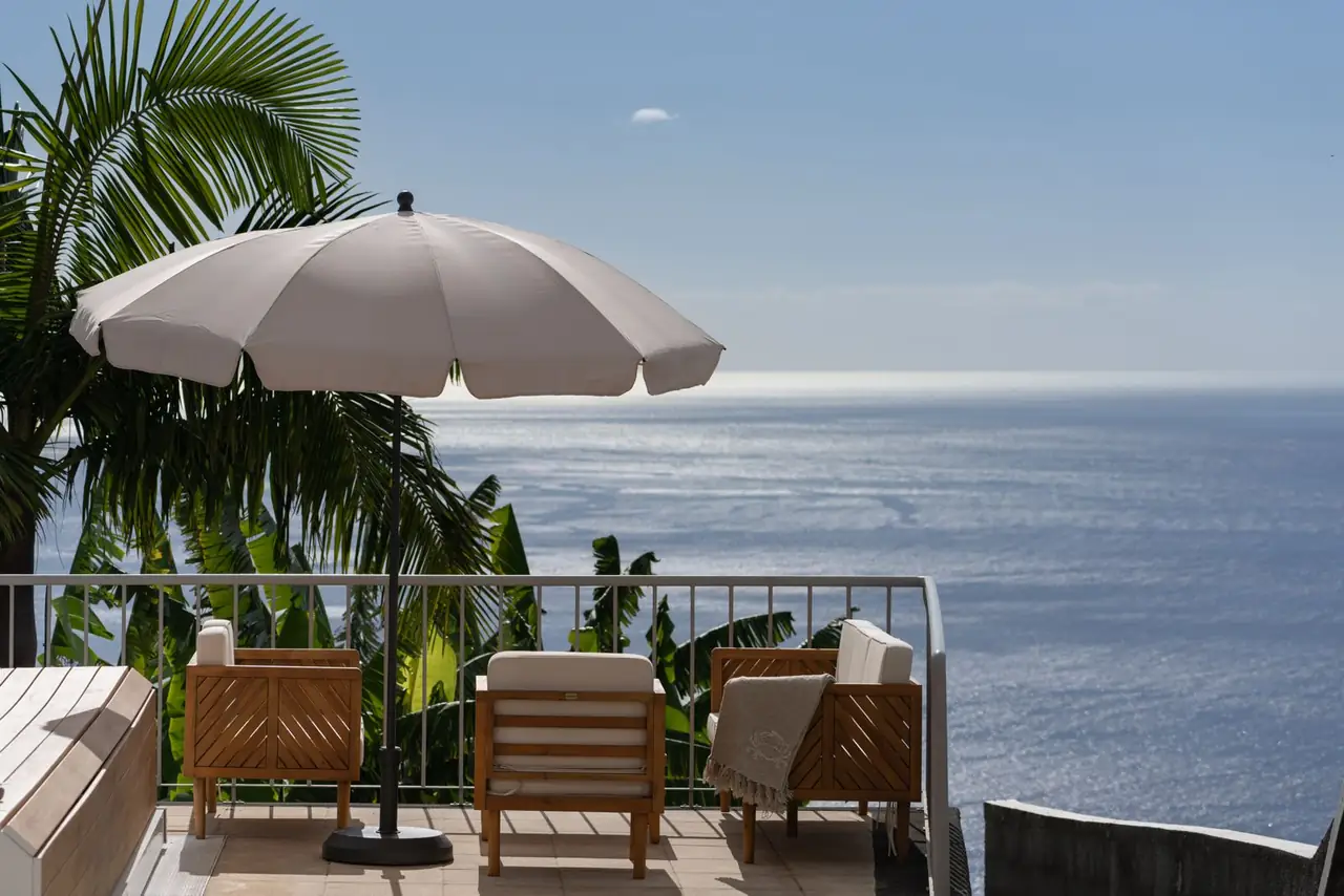Sea-view terrace with lounge chairs and parasol above the Atlantic, Villa Crossdeira